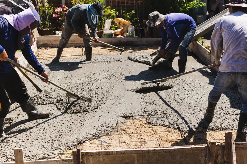 Sản phẩm workers settle level concrete foundation scaled.jpg — Công Ty Cổ Phần Hóa Phẩm Xây Dựng VITEC — MST 0104400394