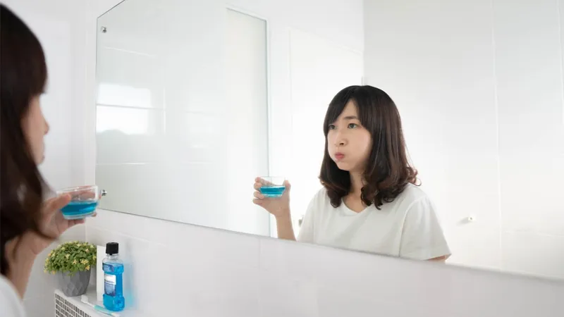 Sản phẩm young asian woman rinsing gargling mouth — COLGATE-PALMOLIVE - Công Ty TNHH COLGATE-PALMOLIVE (Việt Nam) — MST 0300546015