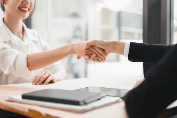 Sản phẩm two businesswomen handshake agreement smiling 600nw 2658451829 — Văn Phòng Công Chứng Chợ Lớn — MST 0306143735