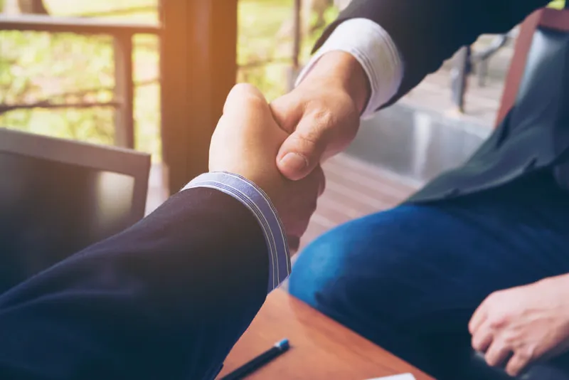 Sản phẩm two businessman shake hand coffee shop 1 1 — Công Ty TNHH Vietnam Global Consulting — MST 0312424893