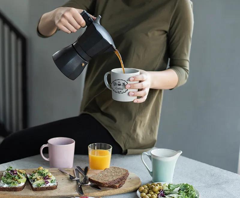 Sản phẩm woman in green top pouring coffee in a white mug 3754296 — Công Ty TNHH D.O.N — MST 0314348729