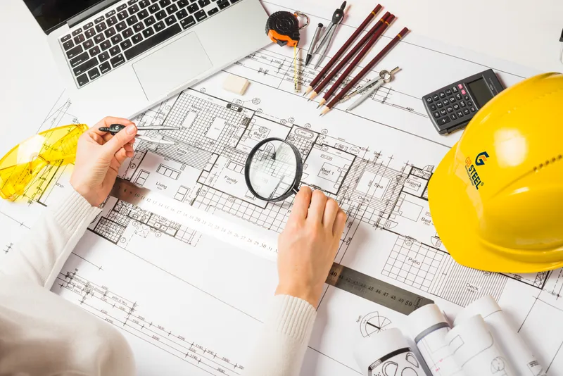 Sản phẩm architectmakingplanwithloupe5627 385 — Nhà Thép Tiền Chế GB Steel - Công Ty TNHH Thép Thông Minh Toàn Cầu — MST 1101998770