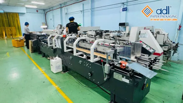 Sản phẩm May dan tu dong 600x338 — Bao Bì ADL Paperpackaging - Công Ty TNHH Một Thành Viên ADL Paperpackaging — MST 3702574723